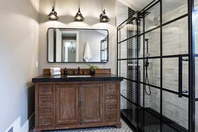 bathroom featuring vanity and tiled shower