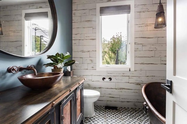 bathroom with tile patterned flooring, vanity, and toilet