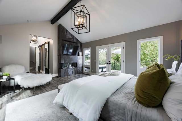 bedroom with access to exterior, vaulted ceiling with beams, an inviting chandelier, a premium fireplace, and hardwood / wood-style floors