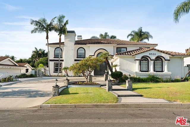 mediterranean / spanish-style house with a front yard