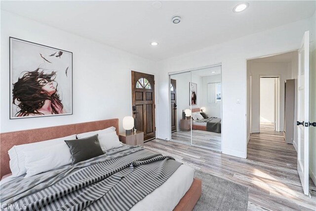 bedroom with a closet and light hardwood / wood-style flooring