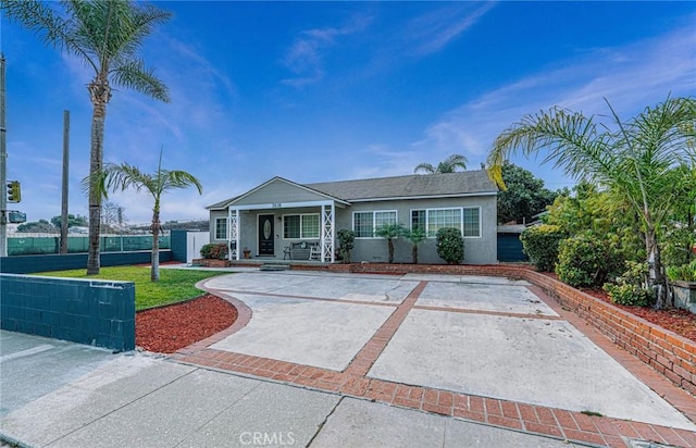 single story home featuring a front yard and covered porch