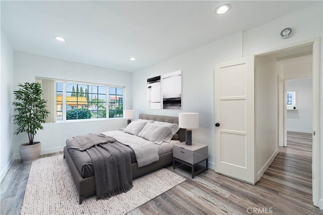 bedroom with hardwood / wood-style flooring