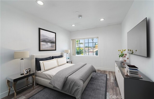 bedroom with dark hardwood / wood-style flooring