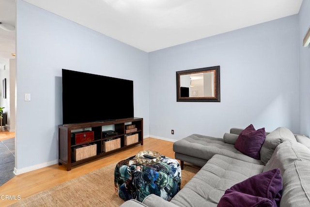 living room featuring baseboards and light wood finished floors