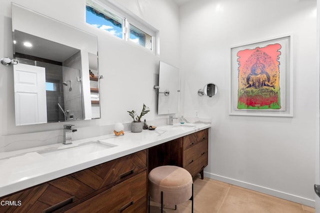 full bath featuring a tile shower, double vanity, tile patterned flooring, and a sink