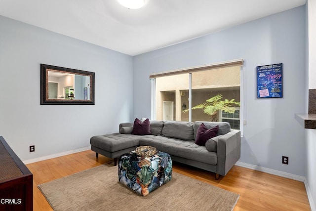 living area with wood finished floors and baseboards