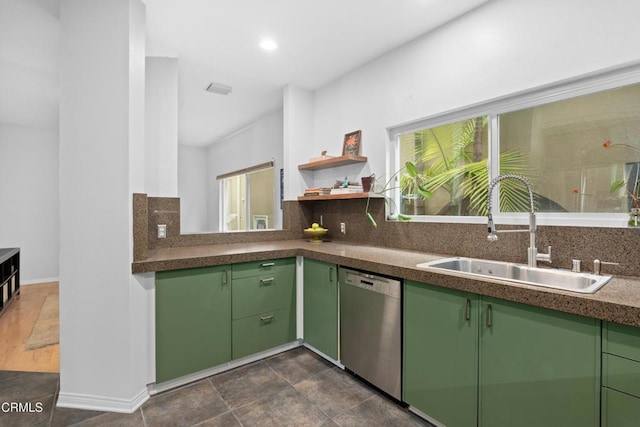 kitchen featuring plenty of natural light, green cabinets, dishwasher, and a sink