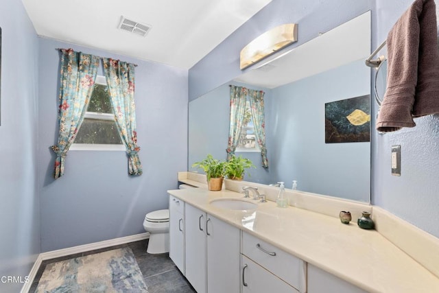 bathroom with baseboards, visible vents, vanity, and toilet