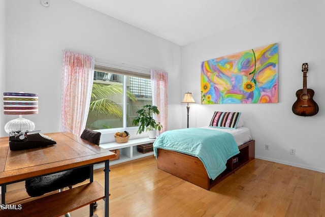 bedroom with baseboards and light wood-style floors