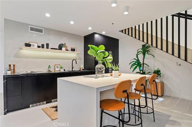 interior space with a kitchen island and sink