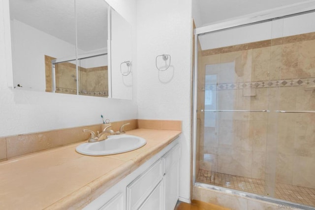 bathroom featuring an enclosed shower and vanity