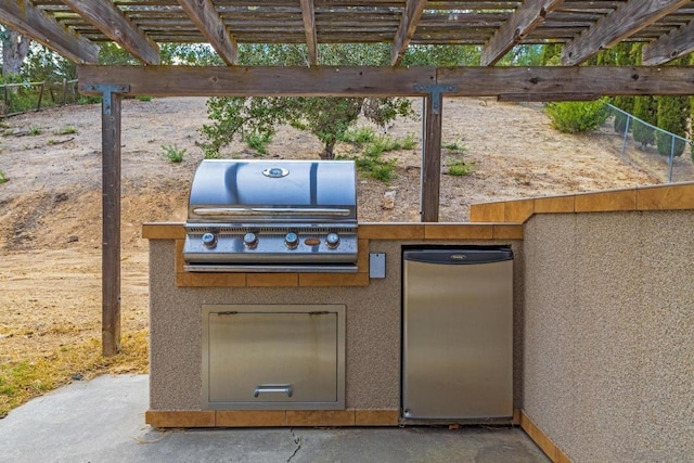 view of patio / terrace featuring an outdoor kitchen, a pergola, and area for grilling