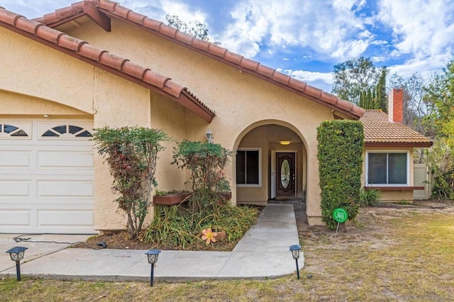 doorway to property with a garage