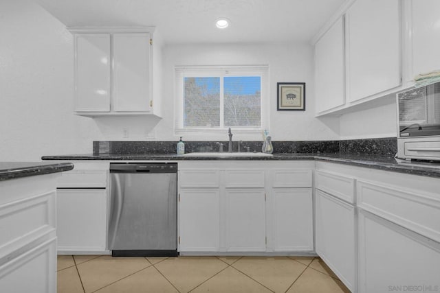 kitchen with light tile patterned floors, white cabinets, and stainless steel dishwasher