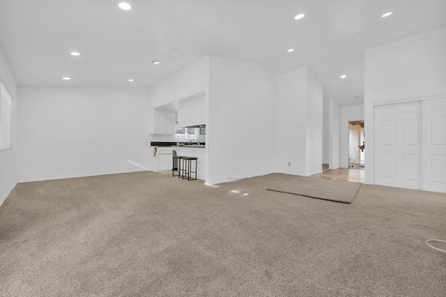 unfurnished living room with a healthy amount of sunlight and carpet floors