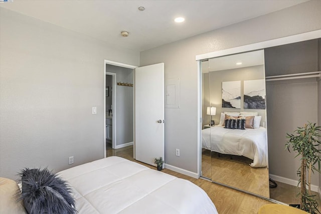 bedroom with a closet and hardwood / wood-style floors