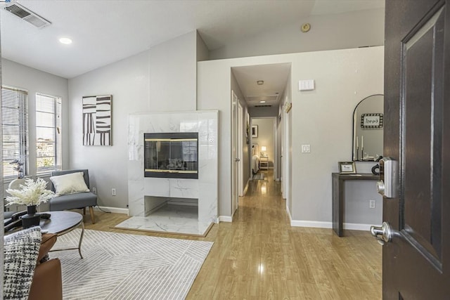 interior space featuring vaulted ceiling and light hardwood / wood-style floors