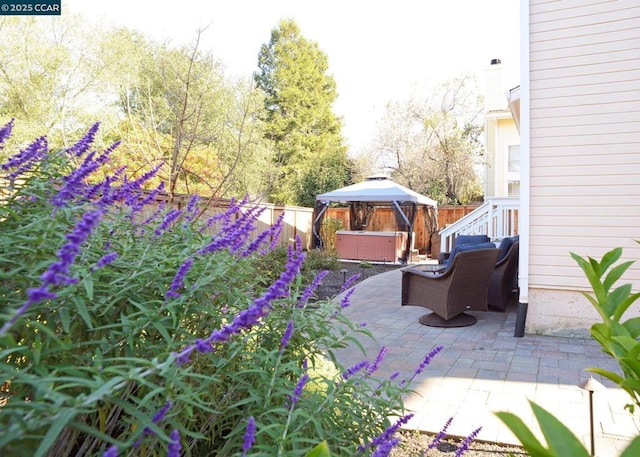 view of patio / terrace featuring a gazebo and a jacuzzi