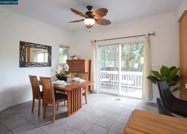 tiled dining room featuring ceiling fan