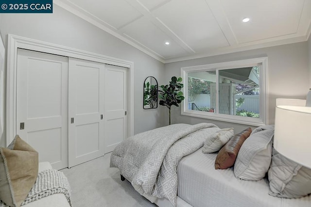 bedroom with light colored carpet and a closet