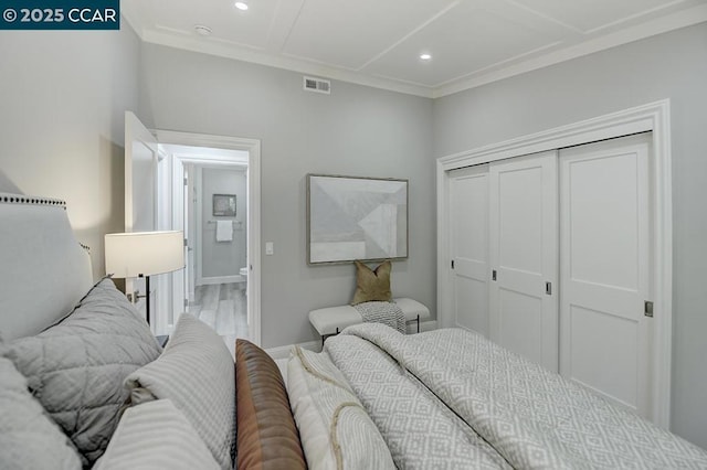 bedroom with light wood-type flooring and a closet