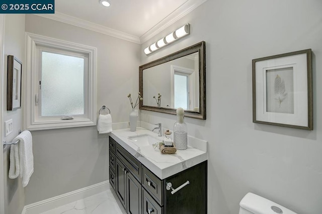 bathroom featuring toilet, ornamental molding, and vanity