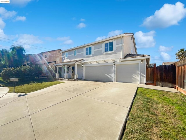 view of front of property featuring a front yard and a garage