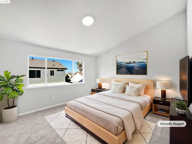 carpeted bedroom with vaulted ceiling