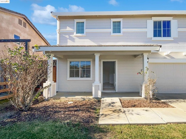 view of front property with covered porch and a garage