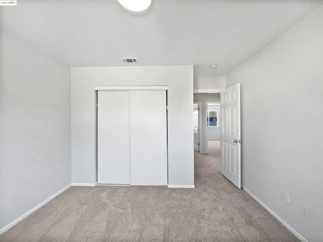 unfurnished bedroom featuring light carpet