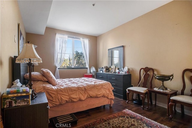 bedroom featuring dark hardwood / wood-style flooring