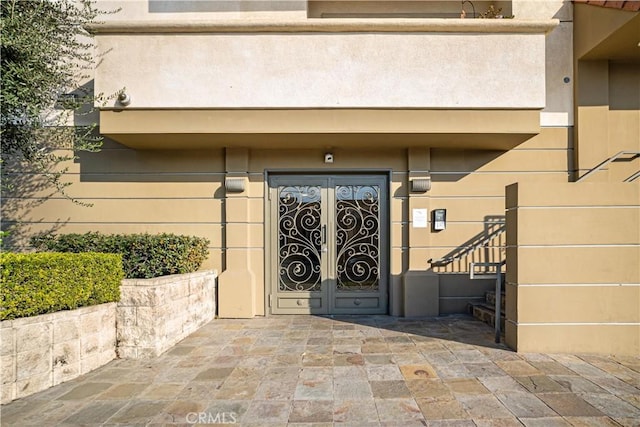 view of exterior entry featuring french doors