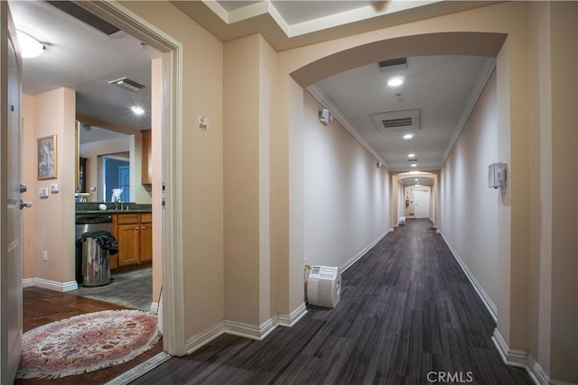 hallway featuring dark hardwood / wood-style floors and ornamental molding