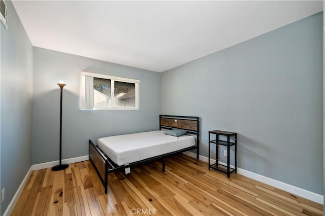 bedroom featuring wood-type flooring