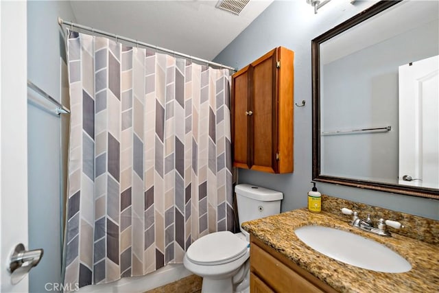 bathroom featuring toilet, vanity, and curtained shower