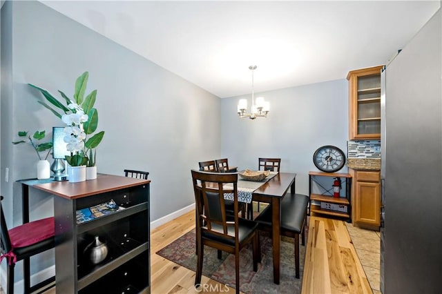 dining area with a chandelier and light hardwood / wood-style flooring