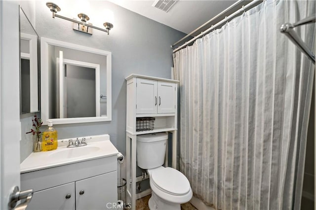 bathroom with toilet, vanity, and a shower with shower curtain