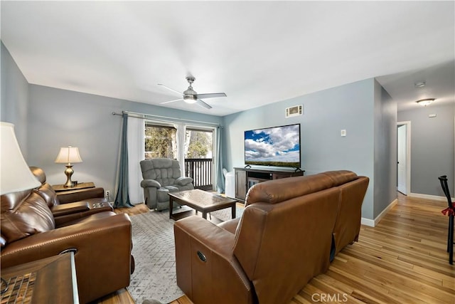 living room featuring light wood-type flooring and ceiling fan