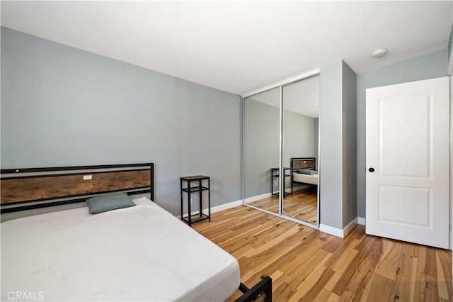 bedroom featuring hardwood / wood-style floors and a closet