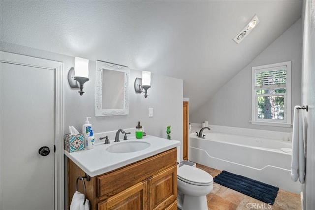 bathroom with vaulted ceiling, toilet, a washtub, and vanity