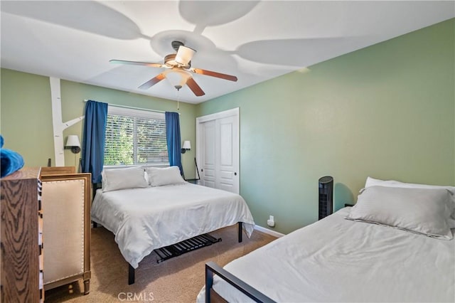 carpeted bedroom with ceiling fan and a closet