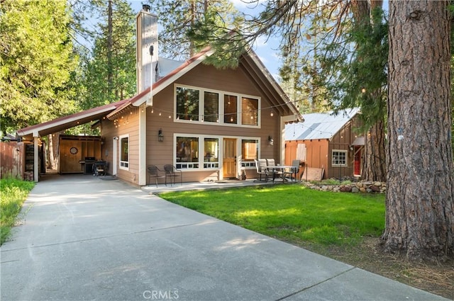 rear view of house with a lawn