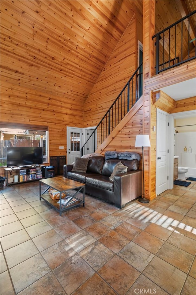 living room featuring high vaulted ceiling, wood walls, and wood ceiling