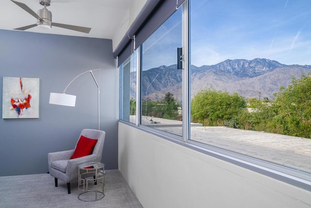 interior space with a mountain view and ceiling fan