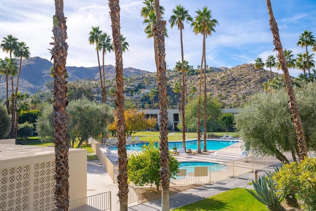 view of swimming pool featuring a mountain view and a patio area