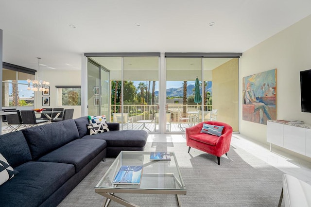 living room featuring a wall of windows and a notable chandelier