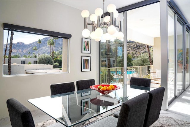 dining area featuring a chandelier and a mountain view