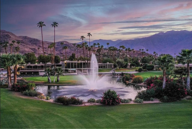 surrounding community featuring a water and mountain view and a yard