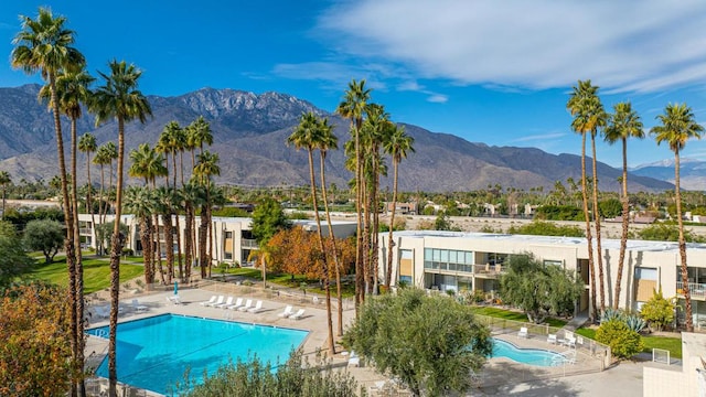 view of swimming pool with a patio area and a mountain view